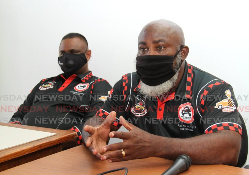 In this May 28 file photo, president of the Trinidad and Tobago Taxi Driver Network and the Chaguanas Taxi Drivers Association Adrian Acosta speaks during a press conference on Coffee Street, San Fernando. Also in the photo is Trustee Haimraj Narine. Photo by Ayanna Kinsale