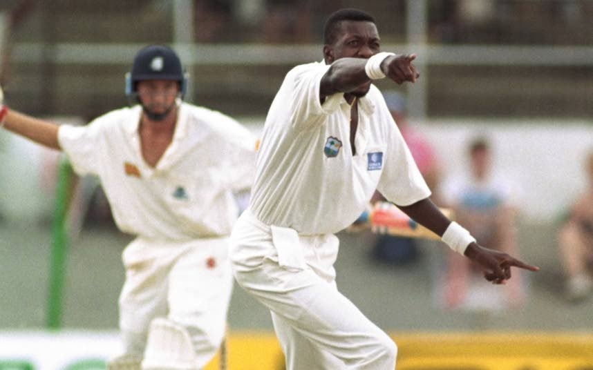 In this March 29, 1994 file photo, West Indies fast bowler Curtly Ambrose (right) traps England batsman Mike Atherton LBW off his first ball on the fourth day of the 3rd Test at the Queen's Park Oval, St Clair.  