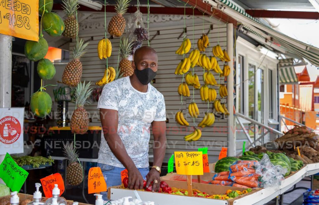 In this file photo, vendor Anthony Durham changed his stock from clothing to fruit and vegetables when government’s covid19 restrictions forced the closure of retail businesses but allowed essential businesses, like those selling food items, operate.  - 