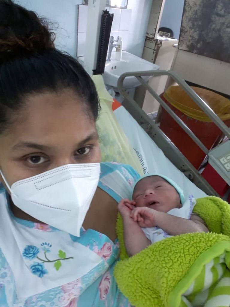MIRACLE: Christine Arjoon and her newborn baby boy, Adonai. Arjoon gave birth in a car at the side of the road in Otaheite after being turned away from the Point Fortin Hospital around 4 am on Tuesday morning. - 