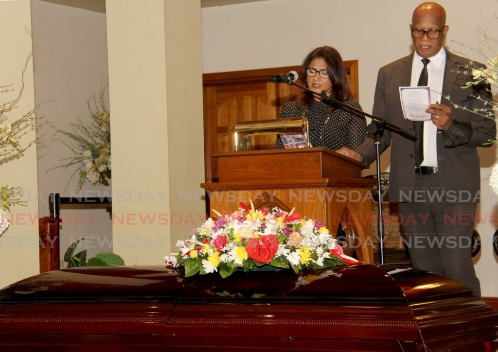 Michelle Mohamed-De Freitas, daughter of Lennox “Bobby” Sylvanus Mohamed, San Fernando Mayor Juna Regrello lead the small congregation in song at Mohamed's funeral at Guides Funeral Home, Coffee Street, San Fernando on Tuesday. - AYANNA KINSALE
