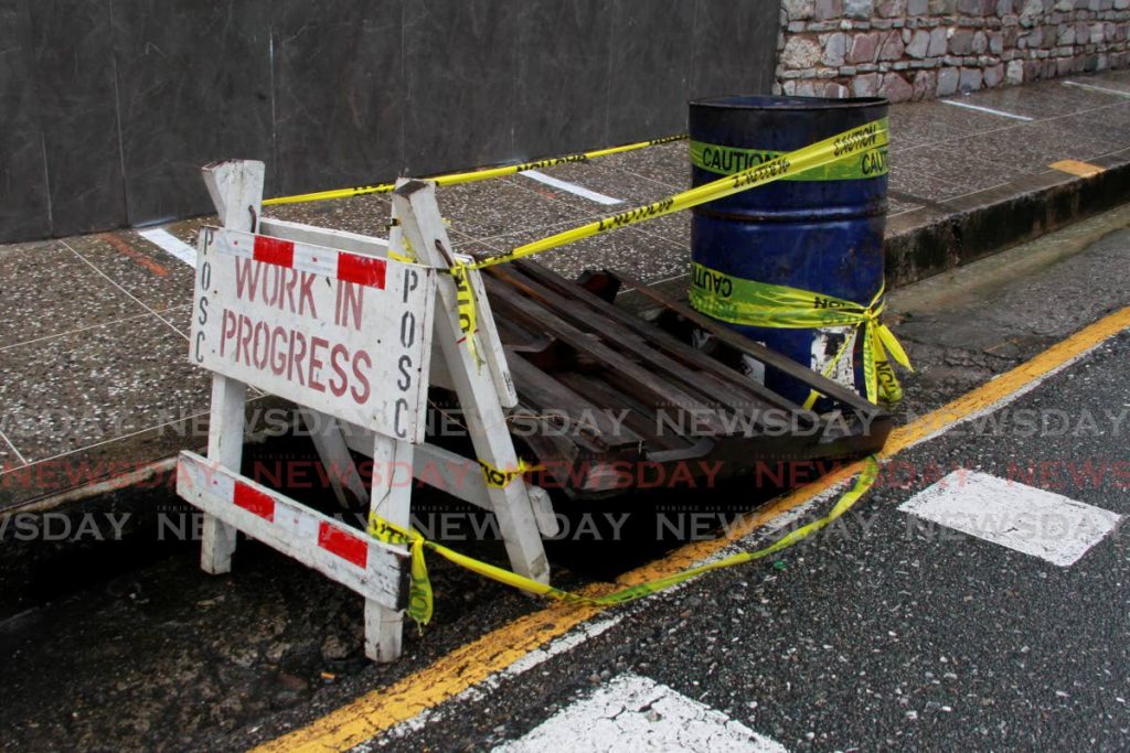 In this June 2021 file photo, a makeshift barrier placed over an open manhole along Upper Henry Street, Port of Spain. Photo by Roger Jacob