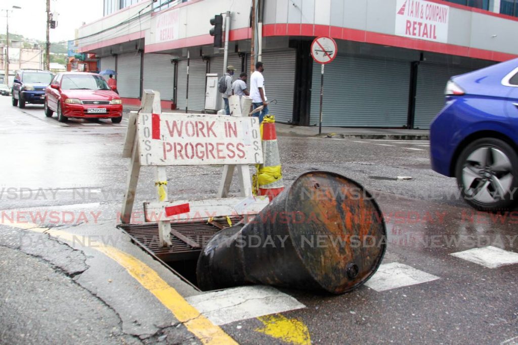 An old steeldrum and wooden barrier placed at the corner of Duke and Frederick Streets, to warn of an open manhole. - ROGER JACOB