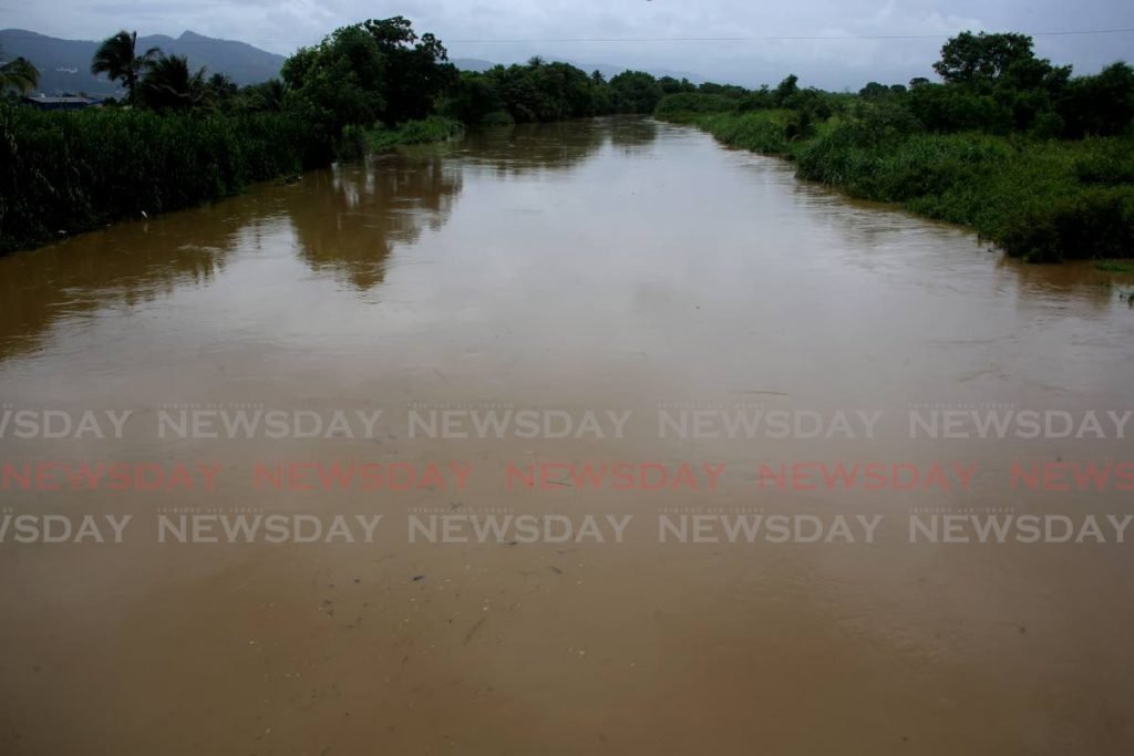 The swollen Caroni River as seen at 11.30 am on Saturday from the Churchill Roosevelt Highway. - SUREASH CHOLAI