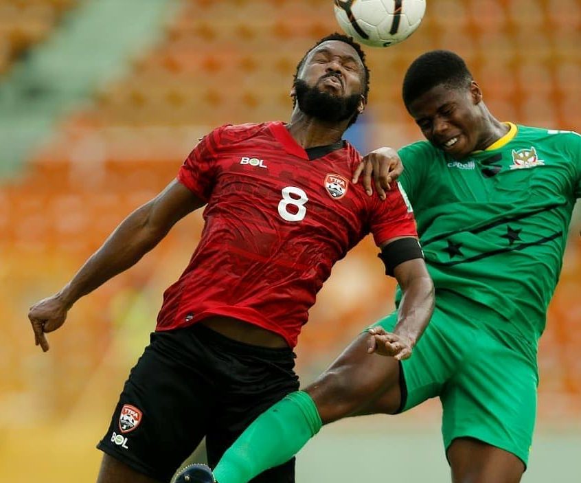 Khaleem Hyland (L) heads the ball in the 2022 Fifa World Cup Concacaf Zone qualifier against St Kitts/Nevis, at the Felix Sanchez Stadium, Dominican Republic, on Tuesday. Photo source TTFA Media