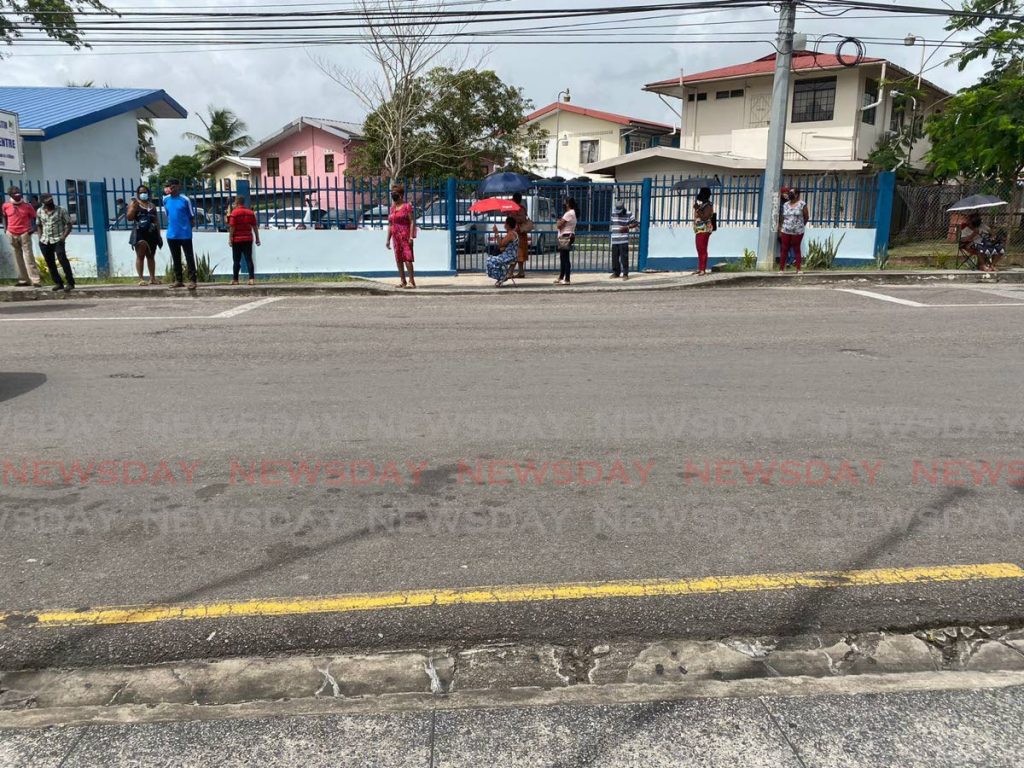Long lines at the Point Fortin Health Centre on Wednesday morning as walk-in covid19 vaccinations began. - 