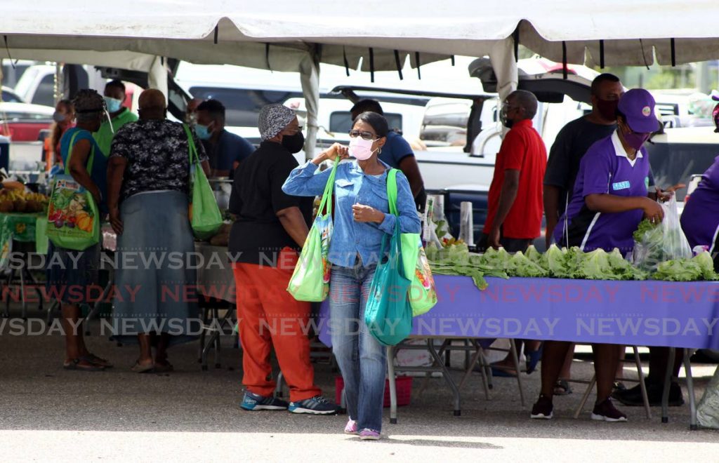 People at the Namdevco farmers' market at the Queen's Park Savannah on June 12. -Photo by Roger Jacob