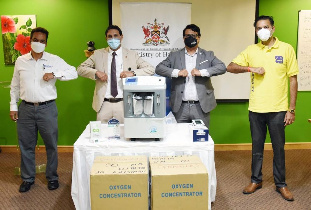 Amerijet's director Simon Pantin, left, CMO Dr Roshan Parasram, Amcham TT CEO Nirad Tewarie and Sewa TT Asst PRO Mark Singh with the medical equipment donated to the Ministry of Health. -                                 