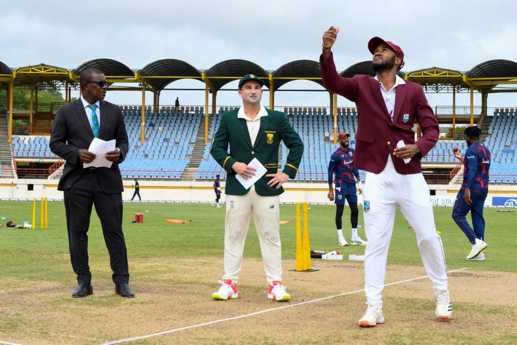 In this photo taken on June 10, Kraigg Brathwaite (R) of West Indies tosses the coin as Dean Elgar (C) of South Africa and match referee Sir Richie Richardson (L) look on during day 1 of the 1st Test between South Africa and West Indies at Darren Sammy Cricket Ground, Gros Islet, Saint Lucia. The second Test match starts on Friday at the same venue. - (AFP PHOTO)