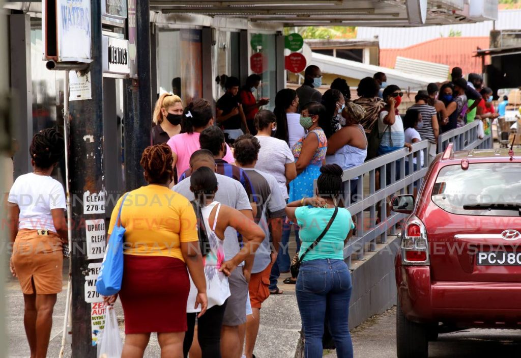 People wait in long lines for the chance to get into West Bees Supermarket in Diego Martin on Friday before the weekend's lockdown begins. - SUREASH CHOLAI