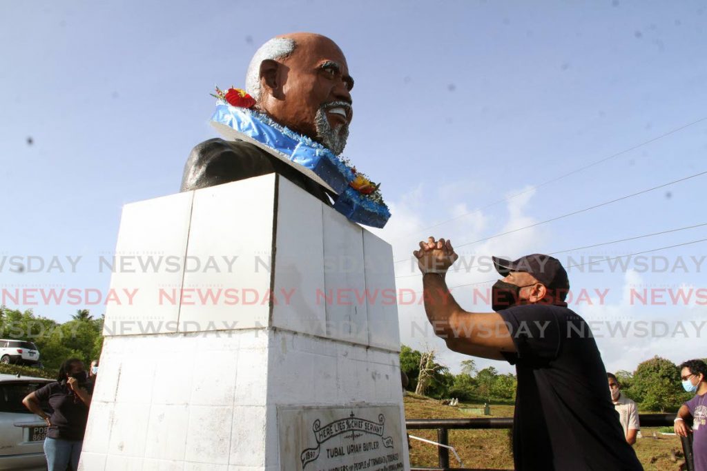 President general of the OWTU Ancel Roget pay respect to the father of the labour movement Tubal Uriah ‘Buzz’ Butler at the Fyzabad cemetery on Saturday.  - Photo by Angelo Marcelle