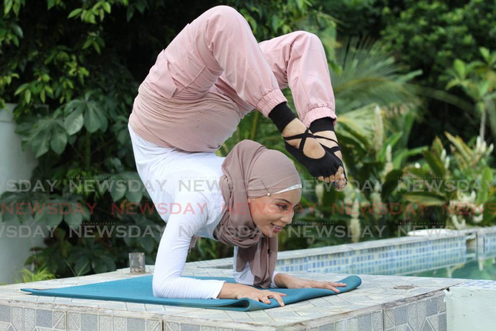 The scorpion is the name of this yoga pose which Shaeeda Sween demonstrates. - Photo by Marvin Hamilton