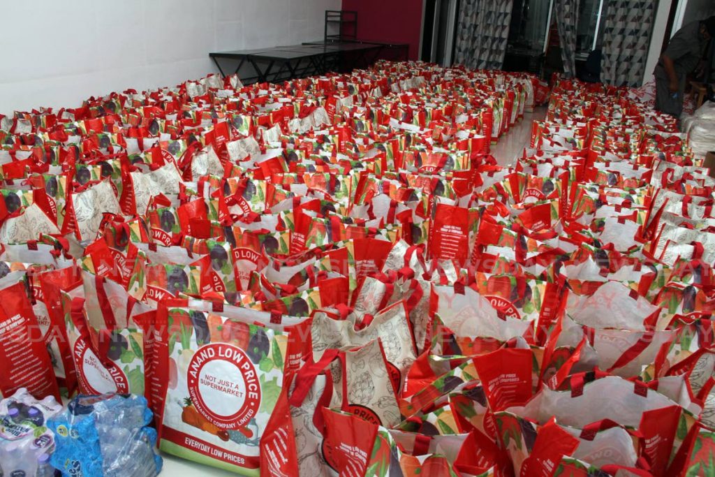 TO BE HANDED OUT: Hundreds of food hampers organised by the  management of South Park Mall in San Fernando, remained uncollected, after police halted the hamper distribution and dispersed a massive crowd on Friday. - Photo by Angelo Marcelle