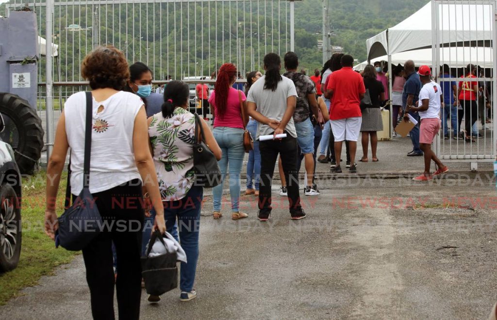 Constrution workers and North West Regional Health Authority employees line up to receive covid19 vaccines at Queen's Park Savannah, Port of Spain on Saturday. - PHOTO BY SUREASH CHOLAI