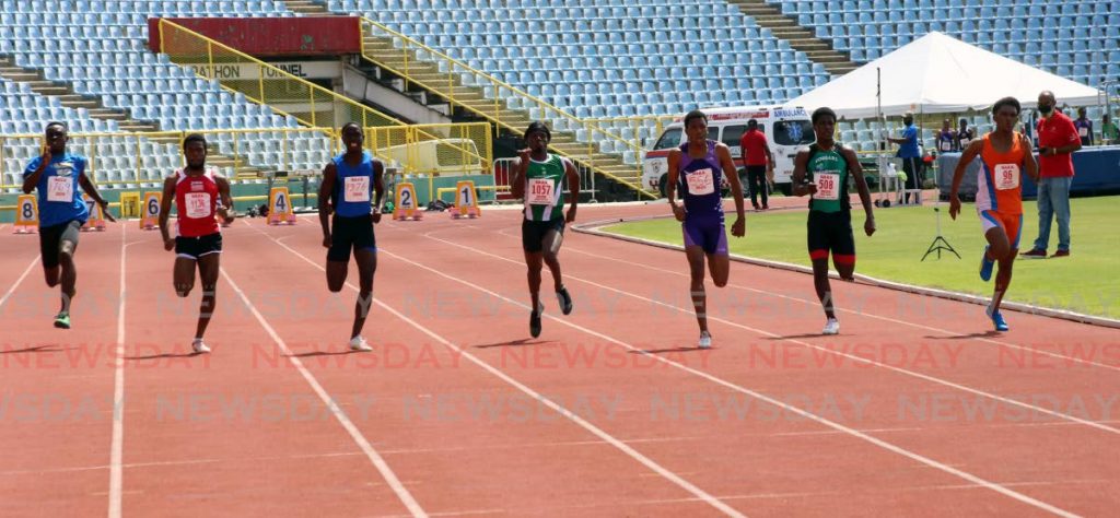 Runners compete in the men’s 100m, at the National Association of Athletics Administrations Olympic trials, on Sunday, at the Hasely Crawford Stadium, Port of Spain.  - SUREASH CHOLAI