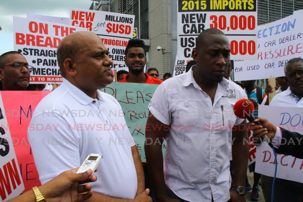 Visham Babwah, president of the Used Car Dealers Association (left) with members during a protest in 2016. - Photo by Roger Jacob