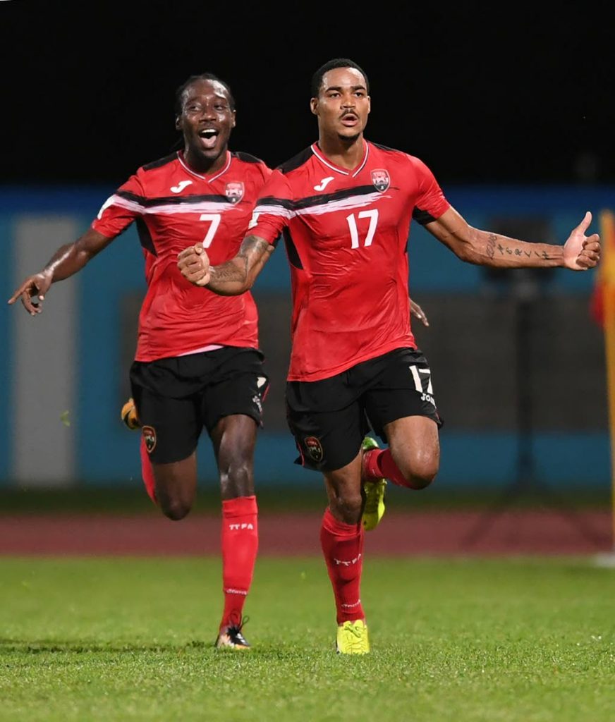 In this October 10, 2017 file photo, TT's Alvin Jones (right) celebrates after scoring against United States during their 2018 FIFA World Cup qualifier football match in Couva. (AFP PHOTO) - 
