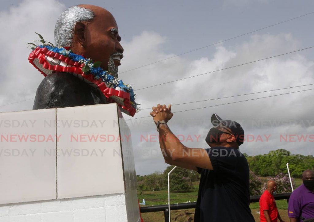 In this June 2020 file photo, Ancel Roget, president general of the Oilfield Workers Trade Union wreaths a bust of Tubal Uriah Butler, founder of the labour movement in TT, at the Fyzabad cemetery at the start of Labour Day celebrations. As the workforce continues to change and evolve, trade unions will have to adapt if they are to remain relevant. - L Holder