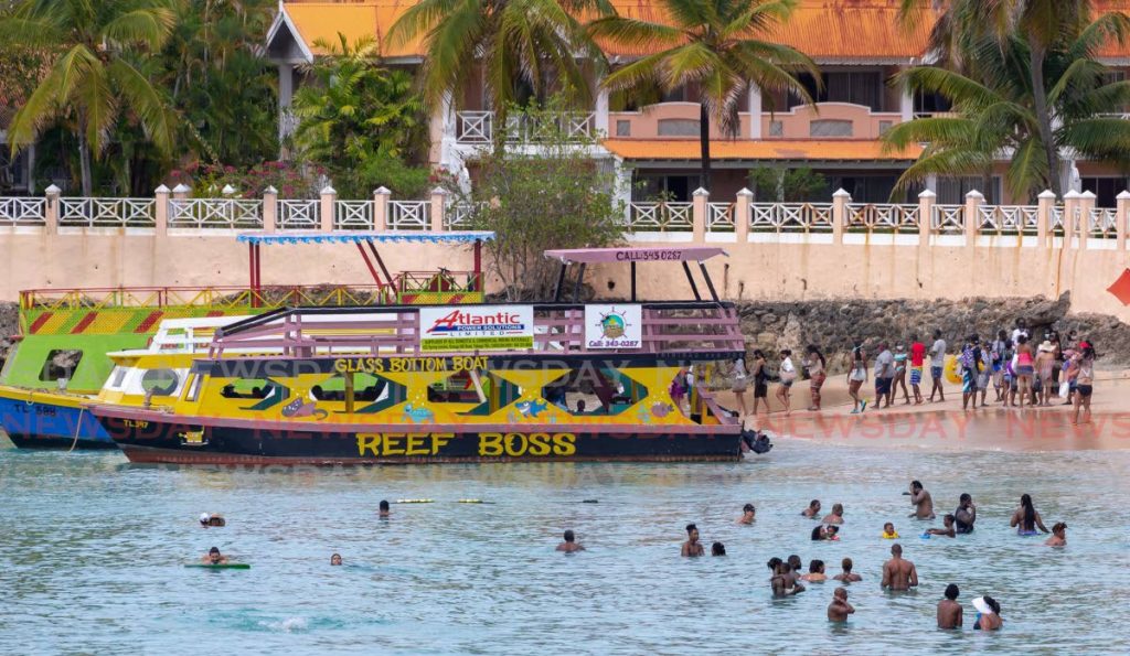 FILE PHOTO: People enjoy a day at the beach in Tobago. - 