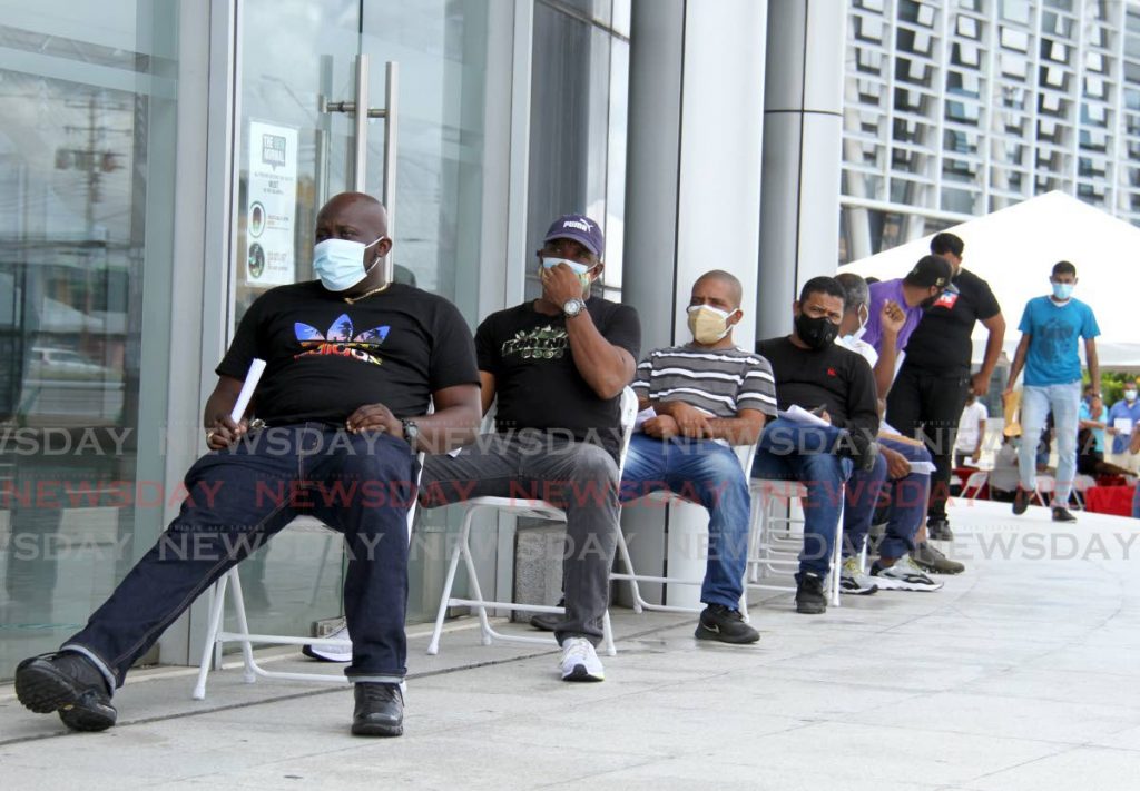Members of the construction sector wait to receive covid19 vaccines at the Southern Academy for the Performing Arts in San Fernando on June 21. - Photo by Ayanna Kinsale