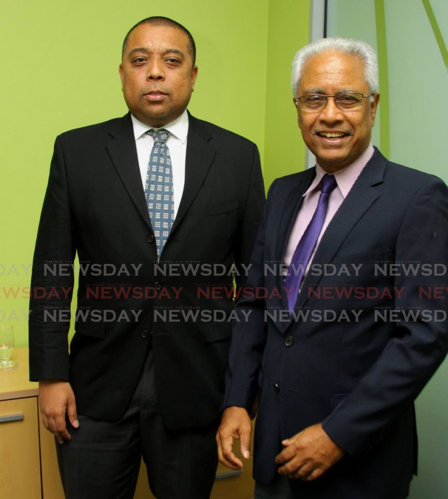 Fair Trade Commission chairman Dr Ronald Ramkisoon, right, and executive director Bevan Narinesingh have been reappointed to their posts for another three years. - File Photo