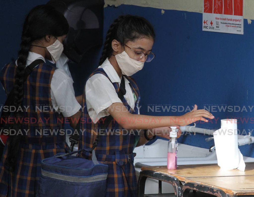 SEA students of Grant Memorial Presbyterian School, San Fernando wash their hands on Thursday morning before going to classroom. - Photo by Angelo Marcelle