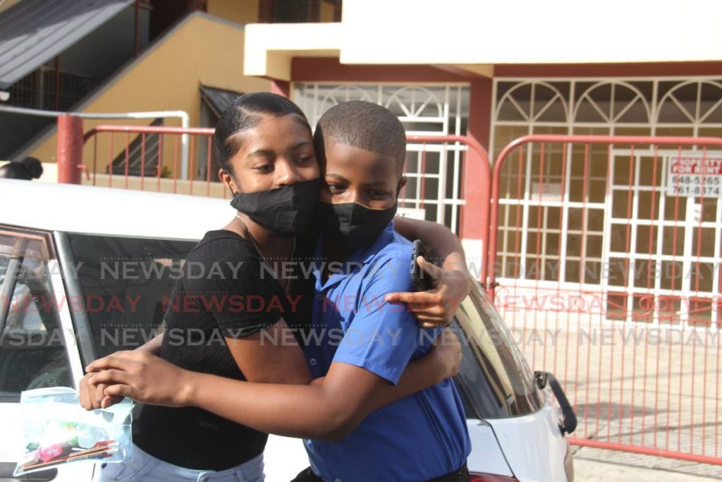GOOD LUCK BRO: Aaliyah Renalis hugs her brother Lenardo before he went into the Point Fortin Seventh Day Primary School to sit the SEA exam on Thursday. Photo by Ayanna Kinsale - 