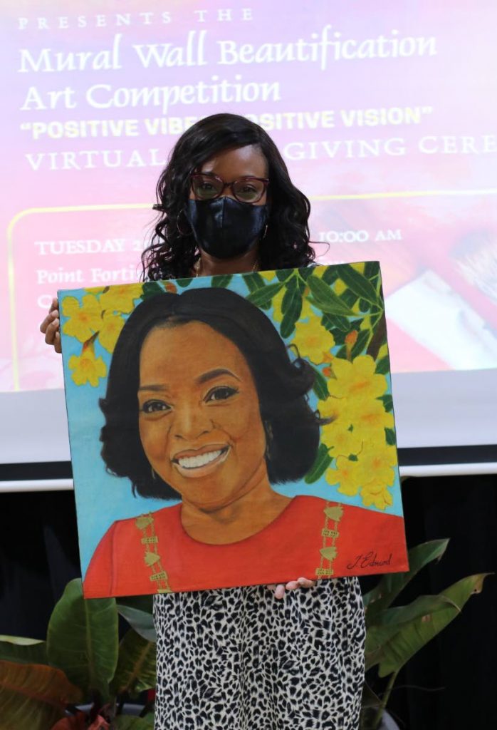 Point Fortin Mayor Saleema Thomas holds a painting of herself, which placed second, by artist Tameeka Edmund in the 18 years-and-over category of the Mural Wall Beautification Art competition put on by the Point Fortin Local Area Planning and Development Committee.  - 