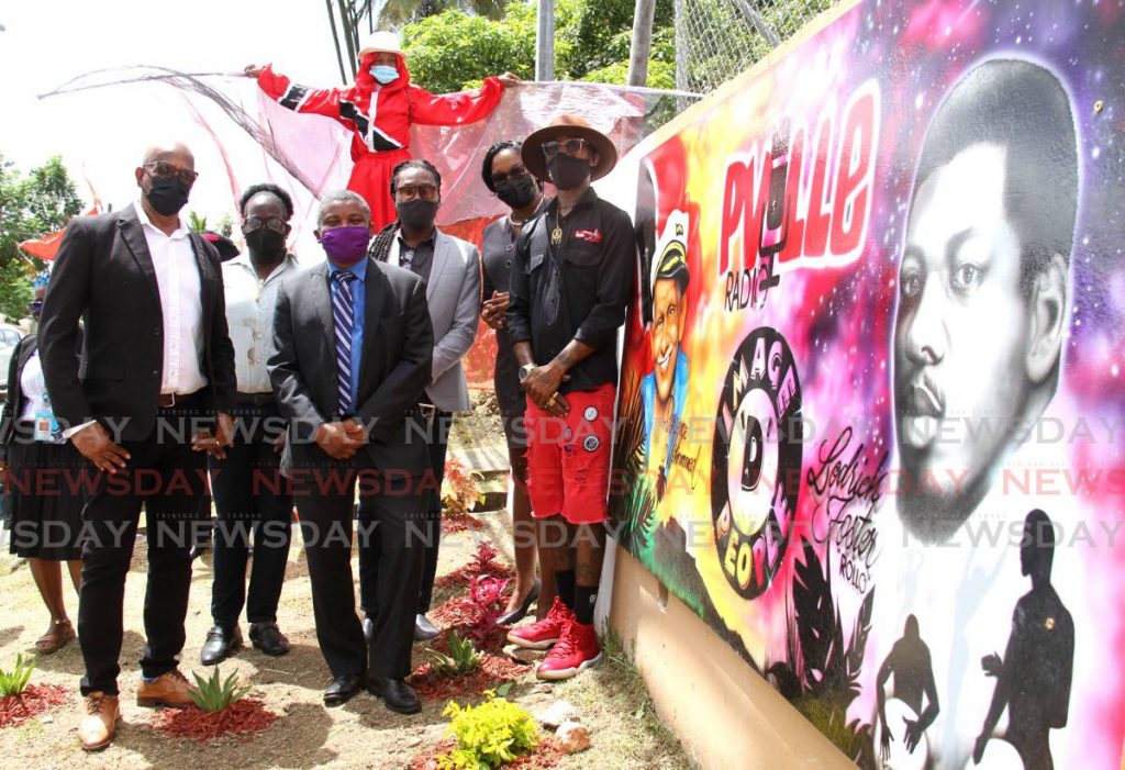 From left, Mayor of San Fernando Junia Regrello, Mckivin Foster, son of Loderick Foster, Councilor Robert Parris, representative of the Mohammed family Deron Attzs, Chairman of the PNM San Fernando East Constituency Patricia Alexis and artist Jason Sealey near the mural in honour of Torrence Mohammed and Loderick Foster on Chaconia Avenue in Pleasntville, San Fernando. - Photo by Ayanna Kinsale