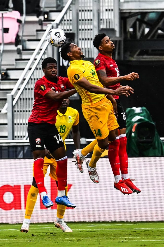 French Guiana's Gregory Lescot (C) and Trinidad and Tobago's Andre Fortune Ii (L) and Trinidad and Tobago's Alvin Jones jump for the ball during the Gold Cup Prelims football match at the DRV PNK Stadium in Fort Lauderdale, Florida, on July 6. - 