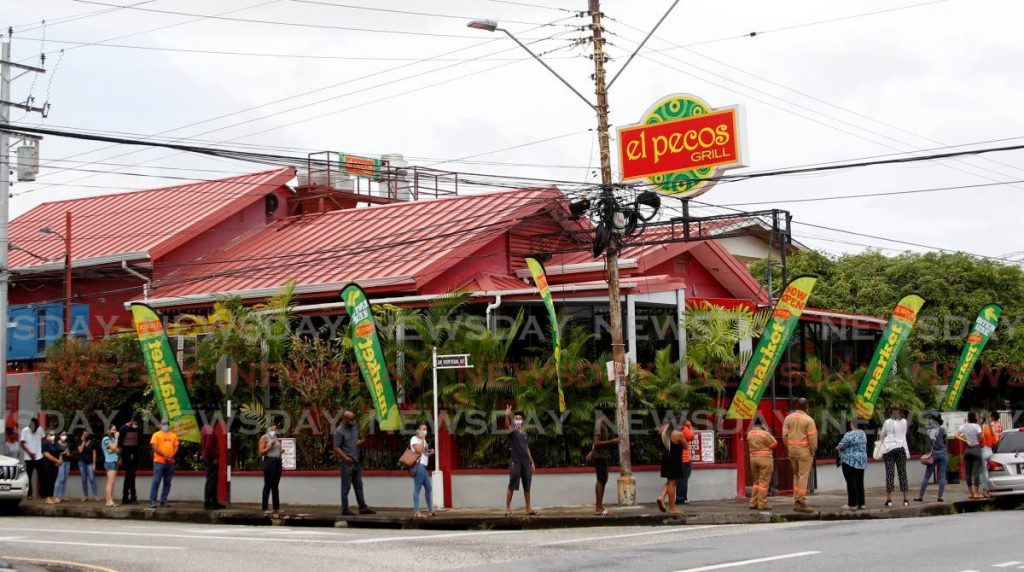 Long lines of people eagerly waiting their turn to purchase grab and go meals from the recently opened El Pecos On The Go Market on July 9. - ROGER JACOB