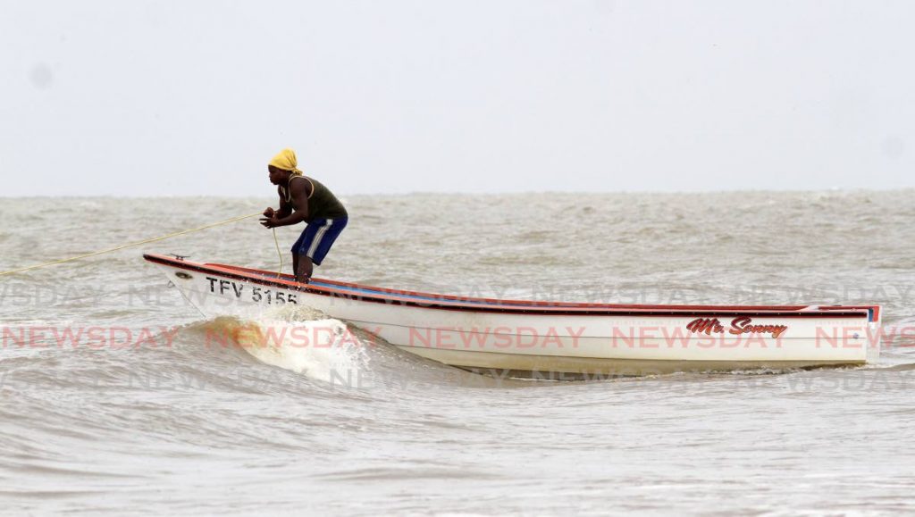 A fisherman anchors his pirogue in Moruga.  - Angelo Marcelle