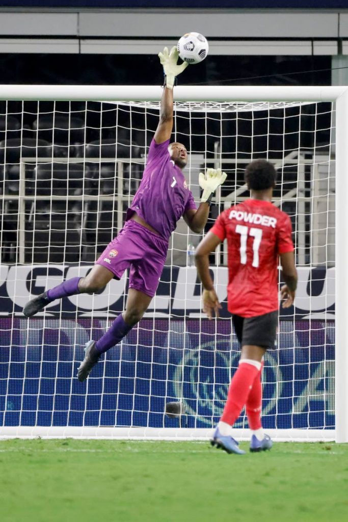 Trinidad and Tobago goalkeeper Marvin Phillip (1) makes a save from a shot by Mexico in front of defender Noah Powder during the second half of a Concacaf Gold Cup Group A match in Arlington, Texas, on Saturday. (AP Photo) - 