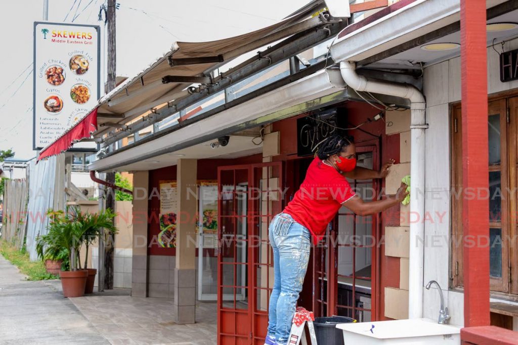 Skewers Middle Eastern Grill, located at Crown Point, Tobago gets ready for the reopening of the food sector. Hadassah Emoriza, a self-employed painter of Plymouth Village, Tobago does some touch up painting at the business place. - David Reid
