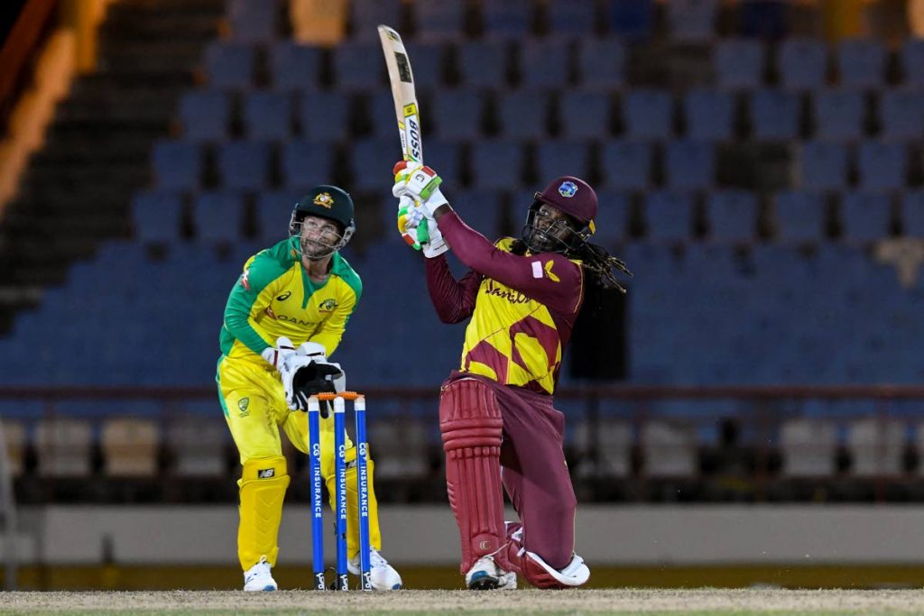 Chris Gayle (R) of West Indies hits 6 as Matthew Wade (L) of Australia watches during the 3rd T20I between Australia and West Indies at Darren Sammy Cricket Ground, Gros Islet, Saint Lucia, on Monday night. West Indies won by six wickets.  - (AFP PHOTO)