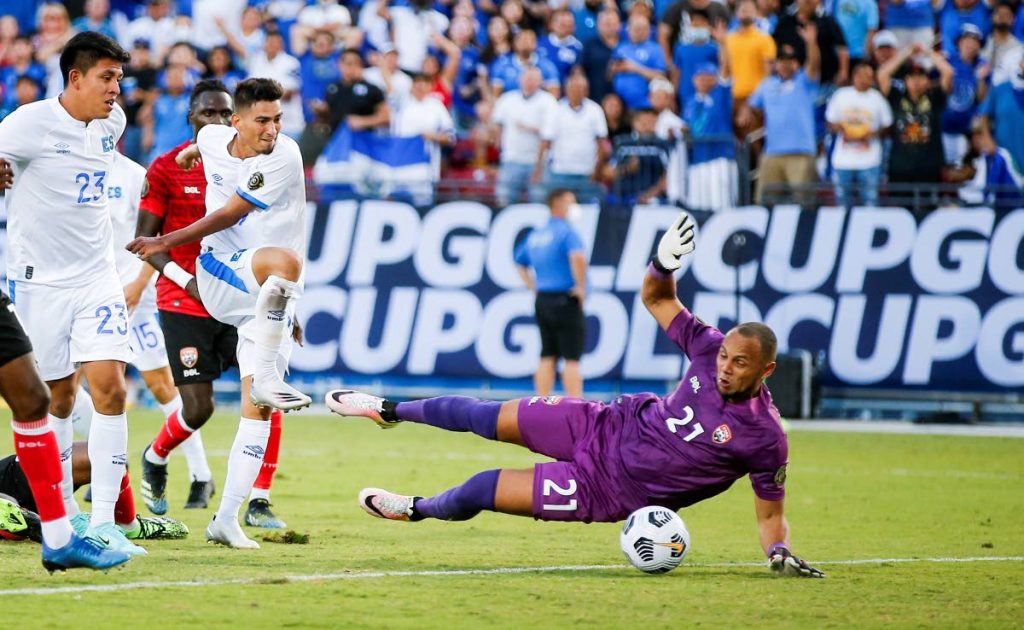 TT goalkeeper Nicklas Frenderup (21) blocks a shot from El Salvador midfielder Juan Portillo, second from left, during a 2021 CONCACAF Gold Cup Group A match, on Wednesday, in Frisco, Texas. El Salvador won 2-0. (AP Photo) - 