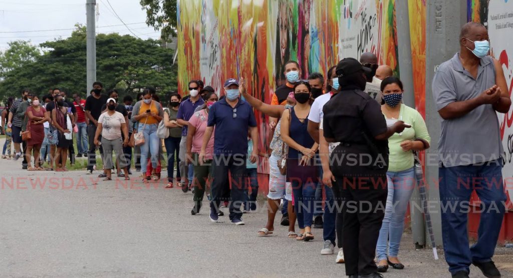 Overwhelming reponse to get their first dose of the Sinopharm vaccine persons in the Food and Beverage Industry and their families queue at the Paddock of the Queen's Park Savannah in Port of Spain on Thursday. Photo by Sureash Cholai