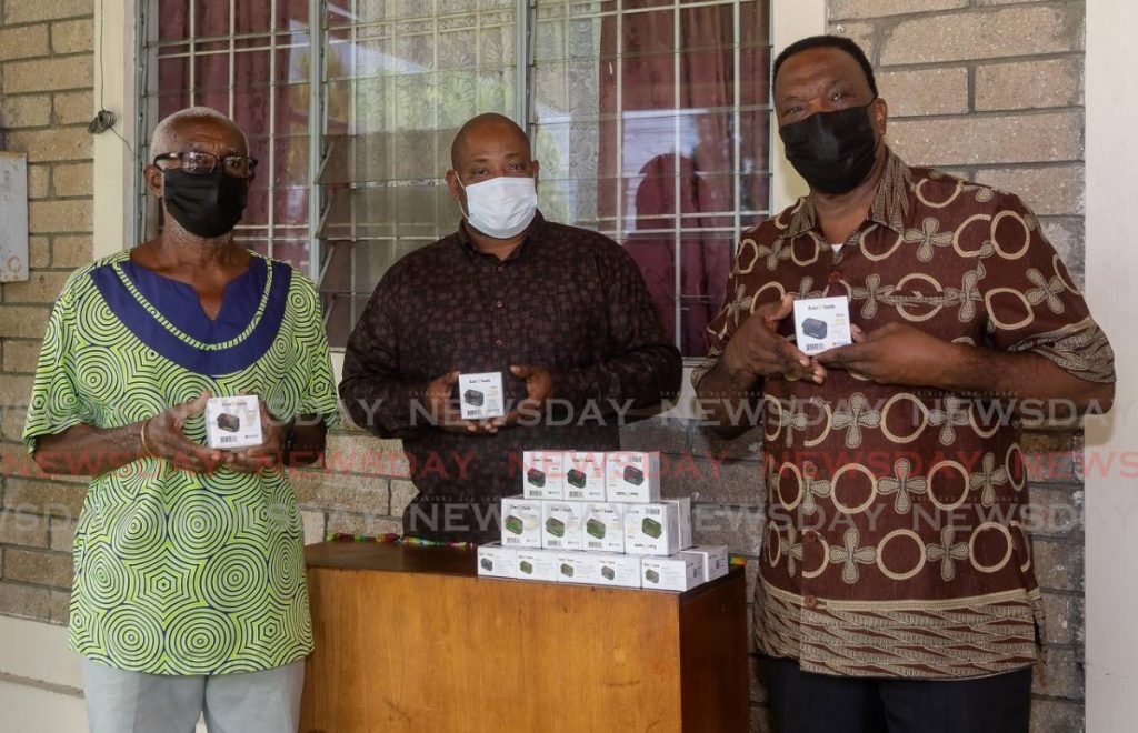 FILE photo: Nigel Walcott, centre, of Island Living Co Ltd donates oximeters to Rudolph Hypolite, left, and Harrace Barton, right, both of the Tobago Association of The Elderly (TATE). Island Living is part of a network of institutions caring for senior citizens. - David Reid