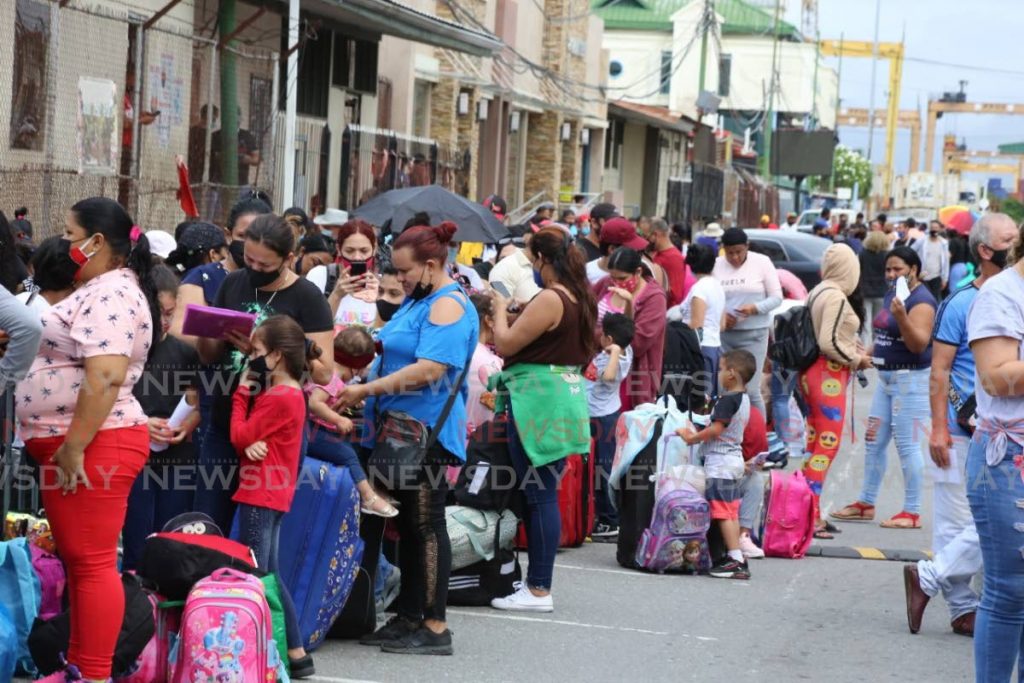 Hundreds of Venezuelans, including children, crowd Wrightson Road, Port of Spain on Saturday morning waiting to enter the Cruise Ship Complex to board a ferry to return to Venezuela. Photo by Sureash Cholai - 