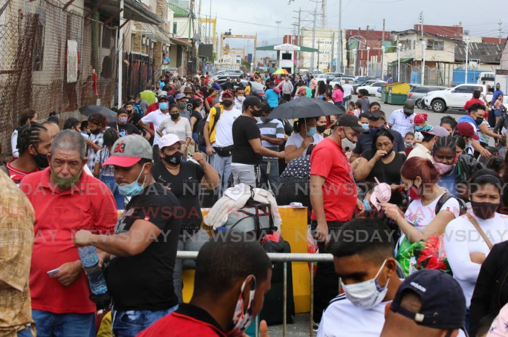 In this July file photo, hundreds of Venezuelans, including children, crowd Dock Road, Port of Spain waiting to enter the Cruise Ship Complex to board a ferry to return to Venezuela. Photo by Sureash Cholai
