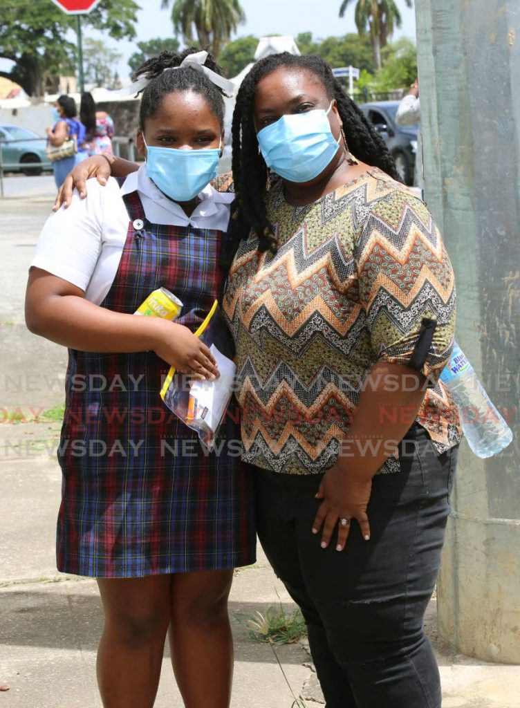 Ayomi Charles was met by her mother Malika Dunbar-Charles after writing Wednesday's SEA make-up exam at the Tranquillity Government Primary School on Stanmore Avenue, Port of Spain. - Sureash Cholai