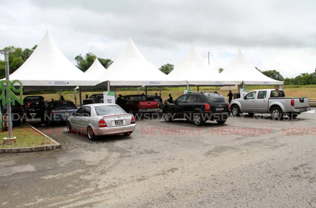 Cars parked in line with the occupants waiting to be attended to during the drive-in mass vaccination programme at the Ato Boldon stadium earlier in the week.  - 