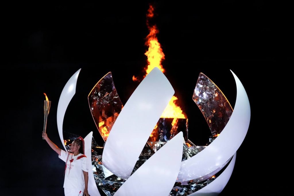 Japan's tennis star Naomi Osaka reacts after lighting the cauldron during the opening ceremony in the Olympic Stadium at the 2020 Summer Olympics, Friday, in Tokyo, Japan. (AP) - 