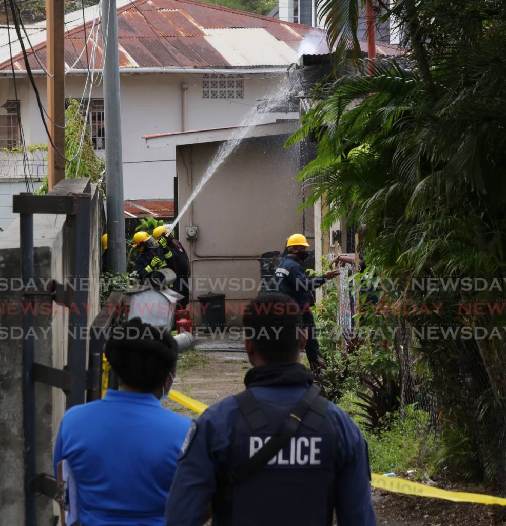In this July 2021 file photo, firemen work to extinguish a fire at a family’s home at No 1 Rookery Nook, Maraval. The blaze claimed the lives of three children aged 17, six and three. Photo by Sureash Cholai