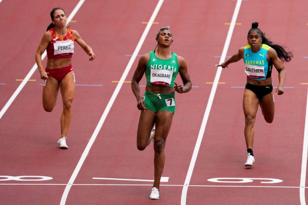 Blessing Okagbare (centre) of Nigeria, wins a heat in the women's 100-metre run at the 2020 Summer Olympics, on Friday, in Tokyo. (AP PHOTO) - 