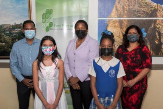Christyana Singh and Excel Beetham Estate Primary School student Akeira George (front row) with Dave Singh, Minister of Housing and Urban Development Pennelope Beckles, and Debbie Singh. - 