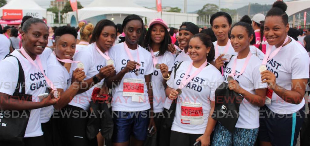 In this September 20, 2017 file photo Coast Guard members display medals after Scotiabank's 5k race against breast cancer at Queen's Park Savannah, Port of Spain. - 