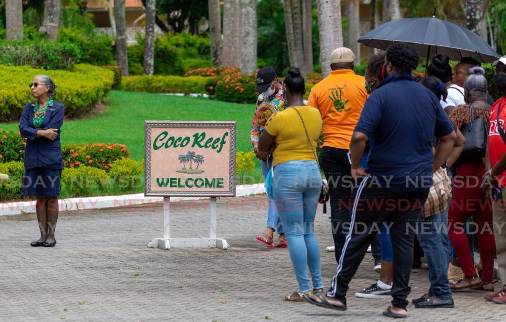 FILE PHOTO: Disgruntled Coco Reef workers speak to a manager after they were sent home without pay in August last year. The popular resort has been temporarily shut down.  - 