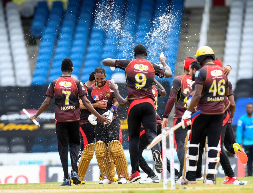 In this September 10, 2020 file photo, Lendl Simmons (2L)  and members of the Trinbago Knight Riders celebrate winning the Hero Caribbean Premier League 2020, at Brian Lara Cricket Academy,Tarouba. - Photo courtesy CPL T20