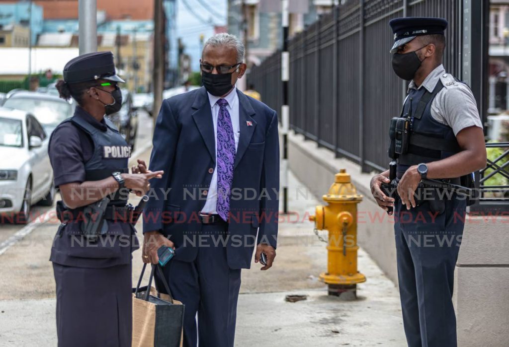 Couva South MP Rudranath Indarsingh speaking with police officers outside Parliament on March 5, 2021. File photo/Jeff Mayers - 